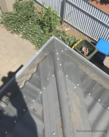A spotless and properly maintained gutter along the edge of a metal shed, free from debris and blockages, in East Nashville, TN.