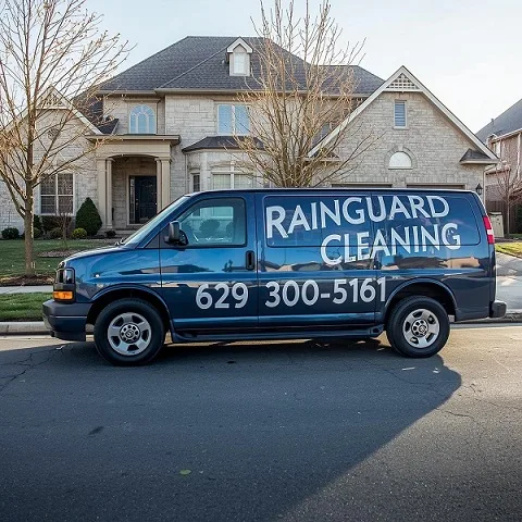 Service pickup van for RainGuard Cleaning,, featuring bold text displaying the phone number (629-300-5161) on the side of the van. Van has parked in front of a house...